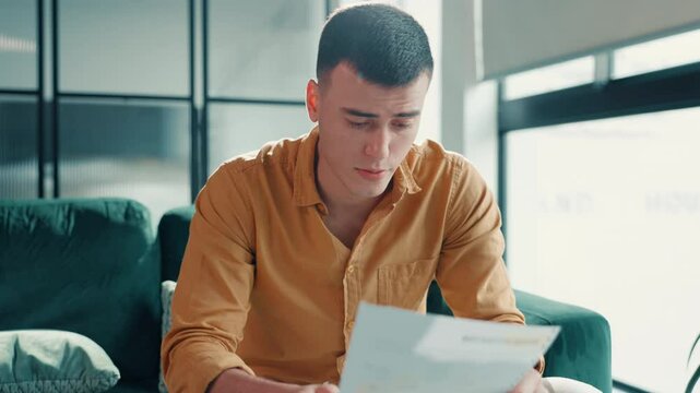 Man, letter and stress in home for debt, payment notice or declined loan with worry in lounge. Invoice document, paperwork and frustrated person in house with mortgage problem, crisis or eviction