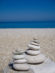 White pebble towers by the beach, minimalist and calm.