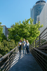 Businesspeople reviewing contract terms on digital tablet outdoors in urban setting