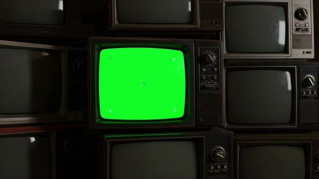 Antique TV sets stacked together in a vintage collection with green screen effects, retro knobs, and buttons reflecting the evolution of old technology in entertainment and historical broadcast media - Powered by Adobe