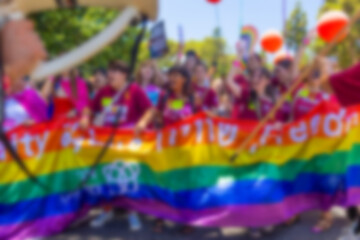 A blurry photo of LGBT parade participants. The movement, the LGBT community. Abstract, blurry, bokeh background.