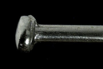 Macro View of a Pinhead with Textured Metallic Surface