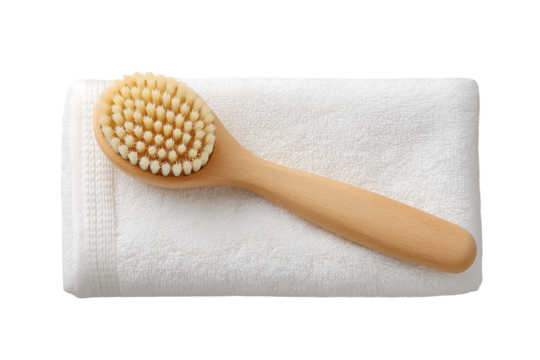 Wooden body brush on a white towel spa bath hygiene wellness