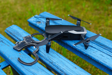 Remote-controlled drone with handcuffs close-up