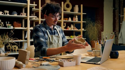 Caucasian man potter artist clay modeling shaping stoneware ceramics pottery decoration crockery...