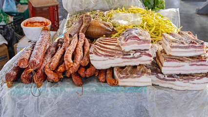 Dry Sausages and Smoked Slabs of Bacon Deli Meat at Farmers Market