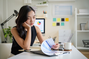 Bored female employee feeling uninspired during a long workday at her desk.