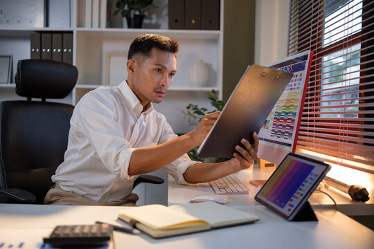 Creative male graphic designer reviewing design elements while working on a digital color scheme project.