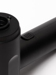 A detailed close up view of a black object placed on a white surface