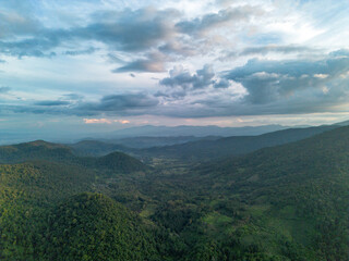 Fototapeta premium High-angle view of green mountain area and traces of agriculture in a northern community in Chiang Mai, Thailand. Beautiful mountain and sky.