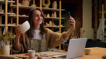 Artist woman creator sculptor art designer potter small business owner saleswoman Caucasian girl blogger influencer social media phone blog video sale crockery handmade craft store pottery workshop