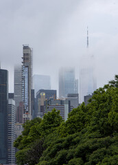 new york city downtown manhattan skyline during fog haze overcast hazy day (tall skyscrapers in...