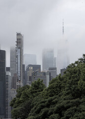 new york city downtown manhattan skyline during fog haze overcast hazy day (tall skyscrapers in...
