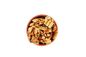 Heap of walnuts in clay bowl isolated on white background.