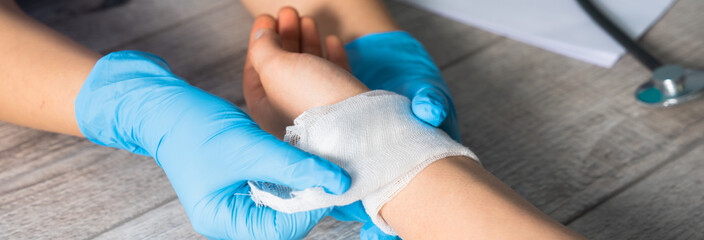 Doctor Bandaging a Patient's Hand