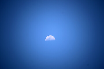 half moon in the  blue sky