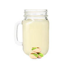 Nut milk in glass jar and pistachios isolated on white