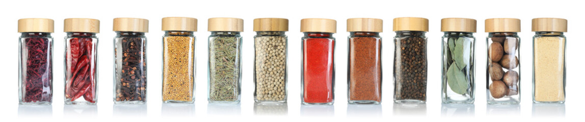 Different spices in glass jars on white background, set