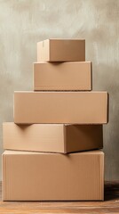 Stacked cardboard boxes of various sizes, elegantly arranged against a neutral background, ideal for themes of packaging, shipping, moving, and storage solutions in photography.