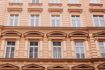 Classic European building facade. Ornamental architecture with symmetry. Rows of windows and...