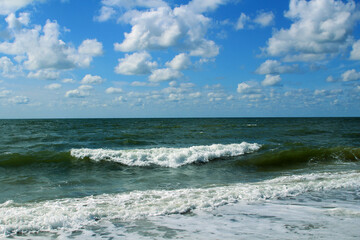 Sunny blue sky with white puffy cumulus clouds over the Atlantic ocean, background (Northern Jutland, Denmark)