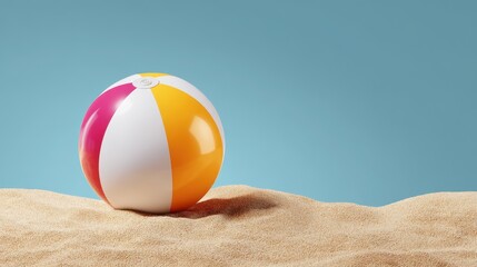 Colorful beach ball resting on sandy shore with a blue sky background, evoking summer vibes and leisure activities.