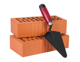 Two orange bricks stacked with a masonry trowel resting on them.