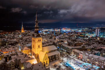Obraz premium Aerial night View of Tallinn in winter, roofs are covered with snow, Christmas mood