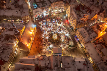 Aerial night View of Tallinn with the Town Hall Square in winter, roofs with snow, Christmas mood