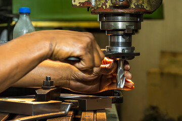 The skill operator working with NC milling machine.
