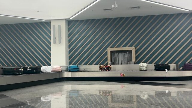 Suitcases or baggage on moving luggage conveyor belt at the airport. Travel concept
