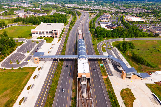 Aerial view of a subway station in Ashburn, Virginia. There is parking and bus stops nearby.