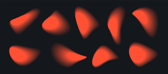 Ten blurred orange shapes appear against a black background. The abstract forms resemble droplets or liquid, displaying gradients and blurred edges, seemingly suspended in space.