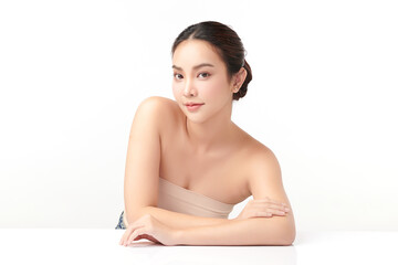 Obraz premium A beautiful young Asian woman with clean, fresh skin against a white background. Skincare, facial treatment, cosmetology, beauty, and spa. An elegant portrait of an Asian woman.