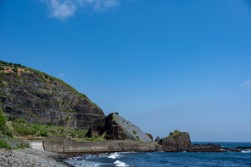 Fototapeta premium Scenery landscape of blue sky and sea seen from Hakodate Esan line of narrow road along the coastal cliffs in Hokkaido, Japan
