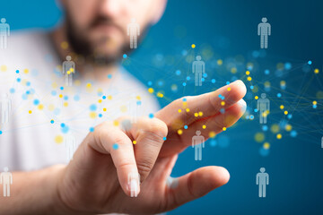 Hand interacting with a digital network of people, representing social media, online networking,...