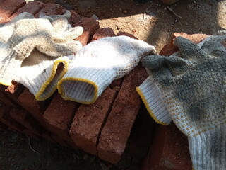 Gloves on red stone, object