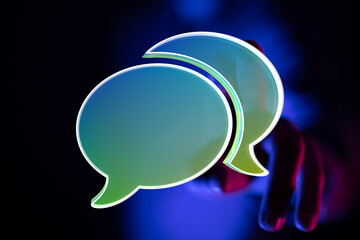 Abstract image of two glowing speech bubbles, representing online communication and conversation.
