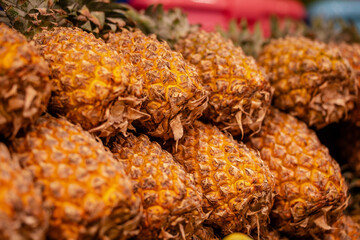 Pineapples on the shelves of a Thai night market
