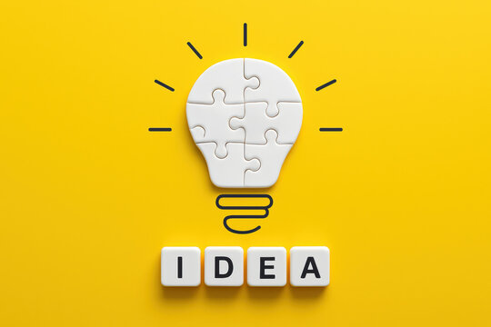 This conceptual design illustrates innovation and creativity through interlocked puzzle pieces forming a light bulb symbolizing insight and problem solving in business
