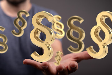 Abstract image of golden paragraph symbols hovering above a hand, symbolizing legal concepts.
