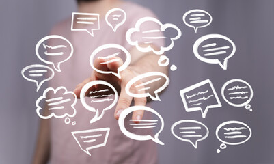 Hand interacting with floating speech bubbles,communication, ideas, feedback concept.