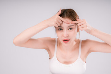 Fototapeta premium Woman is looking at her face Squeeze acne