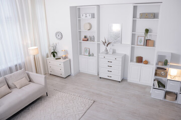 Stylish living room interior. Sofa, dresser, shelving unit and other furniture indoors, above view