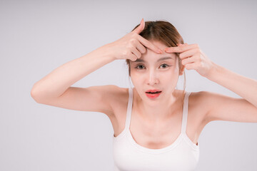 Fototapeta premium Woman is looking at her face Squeeze acne