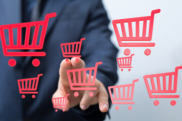 Image of a businessman interacting with digital shopping carts, representing e-commerce and online...
