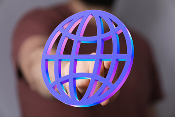 Hand reaching for a vibrant 3D globe, symbolizing global connection and networking.