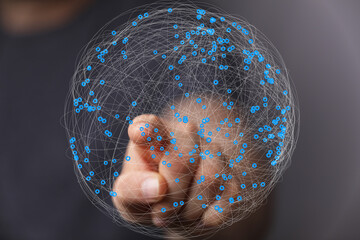 Hand interacting with a digital sphere, illustrating global network and connection.