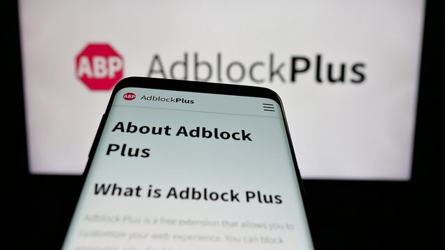 Stuttgart, Germany - 05-29-2025: Mobile phone with website of ad blocking company Adblock Plus (eyeo GmbH) on screen in front of logo. Focus on top-left of phone display.