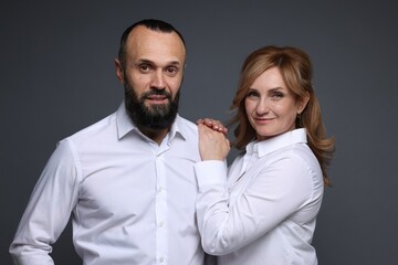 Portrait of lovely couple on grey background